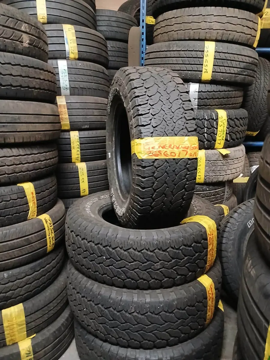 Stacks of part-worn tyres with yellow size labels