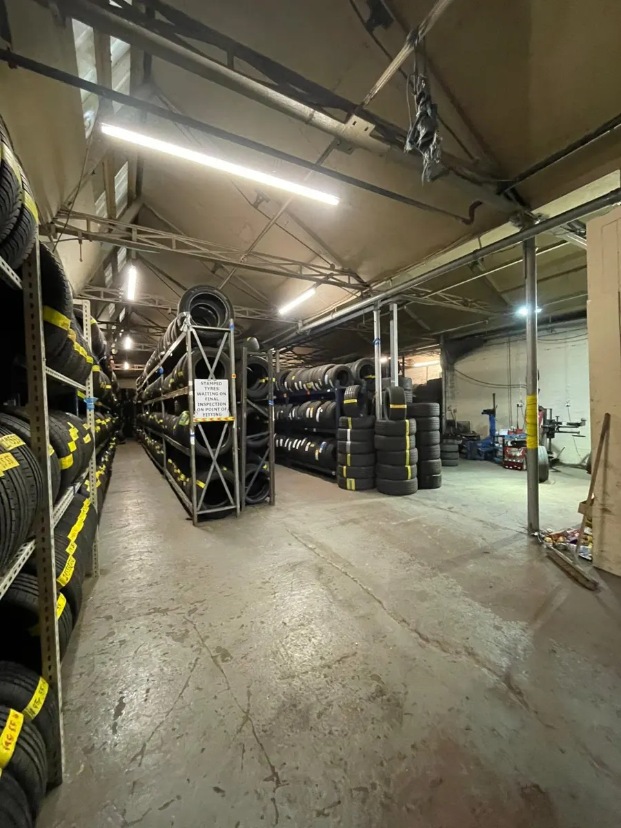 Inside the Paisley tyre warehouse with long rows of racking