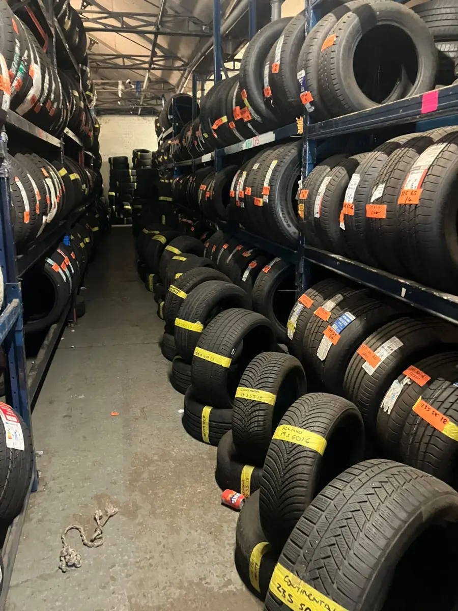 Long aisle of part-worn tyres on racking inside the Paisley tyre centre